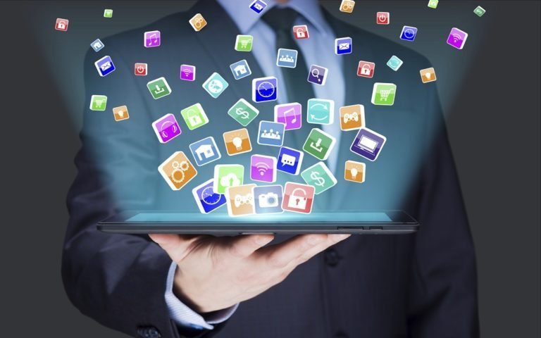 Businessman holding a tablet pc with mobile applications icons on